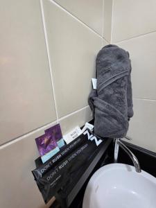 a towel on top of a toilet in a bathroom at Pioneerwoodlands Mandaluyong Studio Unit in Manila +26 photos