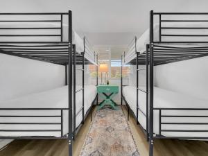 three bunk beds in a room with a table at Drew 251 Mesa in Mesa +22 photos