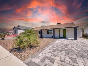 a house with a cloudy sky in front of it at Drew 253 Mesa in Mesa