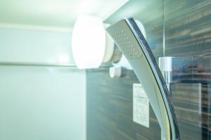a close up of a remote control next to a window at Otter Stay - Sakou in Nagoya +38 photos
