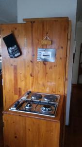 a stove top oven in a wooden kitchen at 33 On Loop, Flat 1 in Ladybrand
