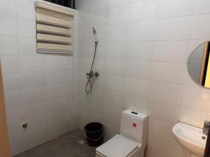 a bathroom with a toilet and a sink at Home in Abuja Municipal Area Council in Abuja +7 photos