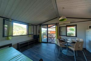 a room with a table and chairs in a house at Lou Gatoun - Cottage Climatisé in Solliès-Toucas
