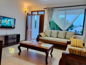 a living room with a couch and a coffee table at 1 bedroom suite Diani in Ukunda Airport