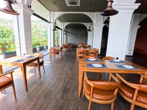 a dining room with wooden tables and chairs at Royal Lion Hotel - Kandy Road, Galagadara in Galagedara