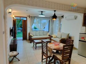 a living room with a couch and a table at 1 bedroom suite Diani in Ukunda Airport
