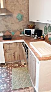 a kitchen with a sink and a counter top at Nicola appartamento in Giba