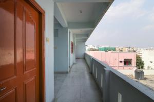 a corridor of a building with a view of a city at Hotel O Krupa Service Apartments in Hyderabad +22 photos