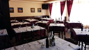 a dining room with tables and chairs with white table cloth at Alla Speranza in San Giórgio di Nogaro