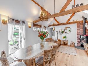 a living room with a wooden table and chairs at Weston Cottage - Uk50016 in Send