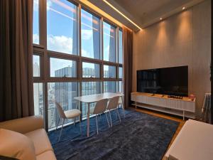 un soggiorno con tavolo e sedie e una grande finestra di Samsung Coex House a Seul