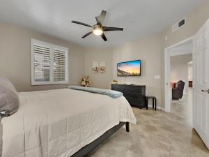 a bedroom with a bed and a ceiling fan at Ground Floor 2 BDR with Garage! Heated Comm Pool! in Mesa +27 photos