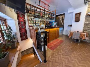 a bar with a counter and a table in a room at Submarine 105 Rooms in Gjirokastër