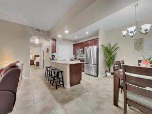 a kitchen and living room with a counter and chairs at Southern #1114 Mesa in Mesa
