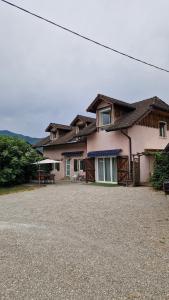 a house with a gravel driveway in front of it at House, Pool and Mountains in Myans