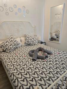 a bed with a black and white comforter and a mirror at Lovely apartment with pool in Costa Del Silencio +43 photos