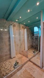 a large bathroom with a shower with a glass enclosure at House, Pool and Mountains in Myans +22 photos