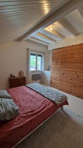 a bedroom with a large bed with a wooden wall at House, Pool and Mountains in Myans