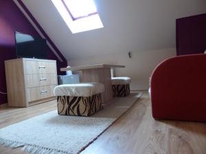 a living room with a couch and a table and a tv at Pokoje u ZośkiP in Zakopane +28 photos
