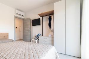 a bedroom with a bed and a closet at One Life Suites in Bibione