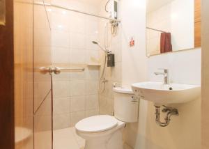 a bathroom with a toilet and a sink and a shower at RedDoorz @ Washington Guest House Olongapo in Olongapo +32 photos