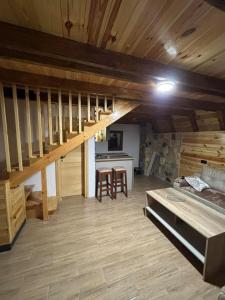 a room with a loft with a bed and a kitchen at Village house Gutovic in Rudinice