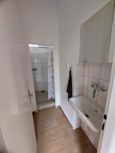 a bathroom with a tub and a sink and a mirror at Ubytování Vločka in Krnov