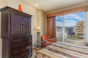 a bedroom with a bed and a dresser and a window at Bella Sirena BA 505 As Good As It Gets Beautiful Ocean View Condo in Puerto Peñasco +16 photos