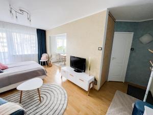 a bedroom with a bed and a television on a table at Jane's Apartment - Free parking in Tallinn