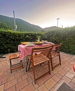 a table and two chairs with a table and a tablecloth at La Casa di Athope in Castel di Sangro