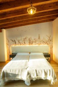 a bedroom with a white bed with a wall mural at HOSTAL BOUTIQUE CAZORLA BAKERY in Cazorla
