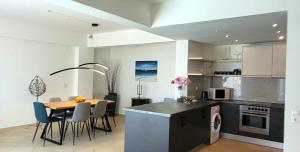 a kitchen and dining room with a table and chairs at Spacious villa with private pool and sea view, just 150 meters from the sea in Istron
