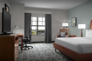 a hotel room with a bed and a desk and a television at Hilton Garden Inn Oklahoma City/Bricktown in Oklahoma City +28 photos