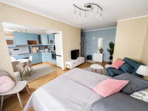 a bedroom with a bed and a living room at Jane's Apartment - Free parking in Tallinn