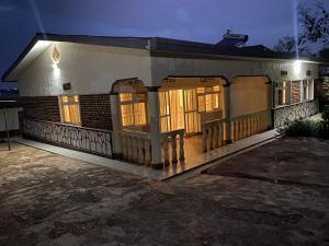 a house with its doors lit up at night at BIZI HOMES in Kigali