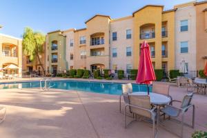 a patio with a table and chairs next to a pool at Mountain View #912 Surprise in Surprise