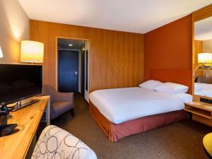 Uma cama ou camas num quarto em Mövenpick Hotel Egerkingen