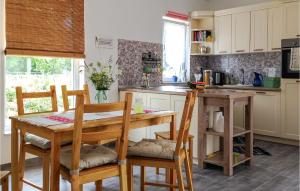 a kitchen with a wooden table and chairs and a table and a counter at Beautiful Home In Sveti Anton With Wifi in Sveti Anton