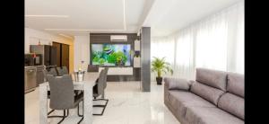 a living room with a couch and a table and a kitchen at Azure Bliss in Costa de Adeje
