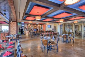 a restaurant with tables and chairs in a room at Wait 'n Sea Retreat Spacious Oceanfront Condo in Puerto Peñasco