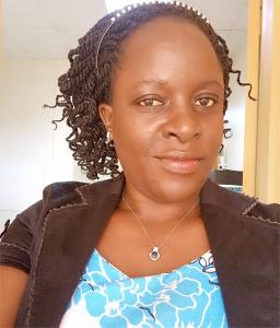 a woman with curly hair wearing a necklace at Tenzi BnB in Jinja