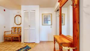 a hallway with a bench and a mirror and a chair at Silver Bear 18 Condo in Mammoth Lakes