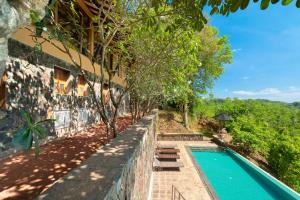 a house with a swimming pool next to a building at Cinnamon Museum Mirissa in Mirissa
