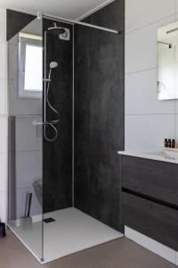 a shower with a glass door in a bathroom at Recreatiepark de Markplas in Opheusden