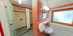 a bathroom with a sink and a toilet and a window at DJH Bautzen Gerberbastei in Bautzen +8 photos