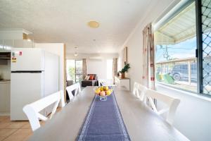 a kitchen with a table with a bowl of fruit on it at Townsville Family Getaway in Townsville