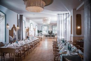 a row of tables and chairs in a room at Hotel Nysa in Nysa