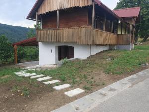 a house with a building with a porch at Jadrica in Žumberak +5 photos