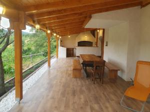 a dining room with a wooden table and benches at Jadrica in Žumberak