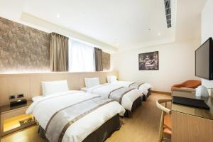 Rúm í herbergi á HE TI Hotel